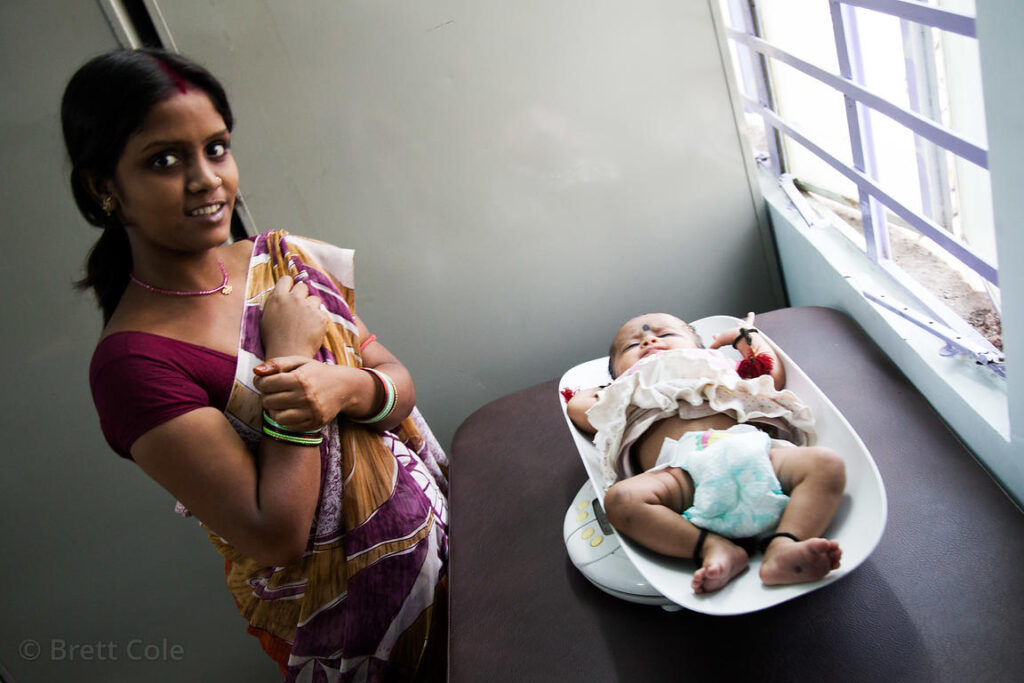 Indian mother breastfeeding newborn baby at home