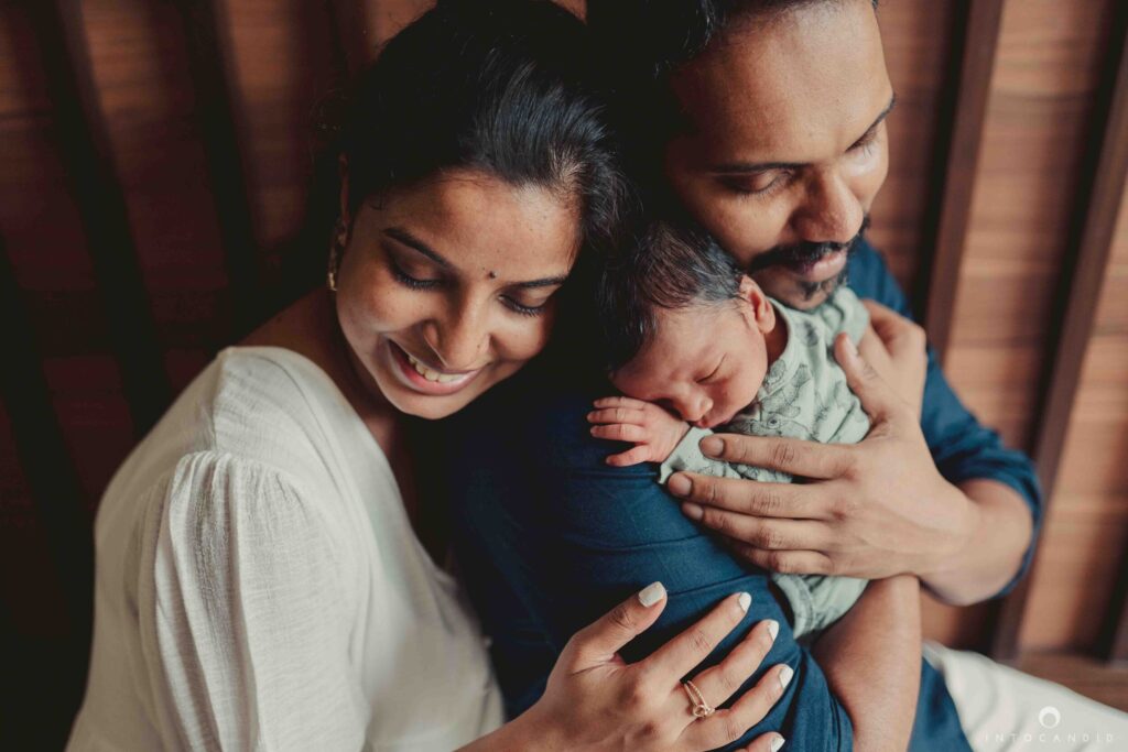 Indian mother breastfeeding newborn baby at home